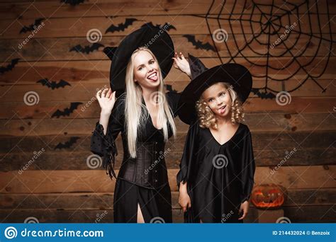 Halloween Concept Cheerful Mother And Her Daughter In Witch Costumes