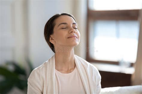 Content Woman Sitting On Sofa With Closed Eyes Breathing Air Stock Image Image Of Moment