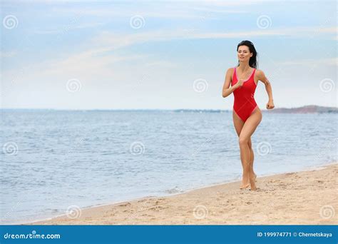 Beautiful Female Lifeguard Running At Sandy Beach Stock Image Image