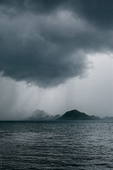 Storm Over Island In Ocean Del Colaborador De Stocksy Julia Volk
