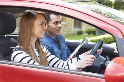 woman having driving lesson with instructor driving instructors association