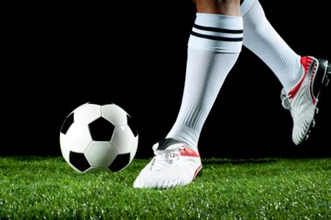 Close Up Of A Man Kicking Soccer Ball Stock Photo Download Image Now