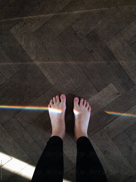 Woman S Feet Standing On The Wooden Floor With A Rainbow By Stocksy Contributor Amor Burakova