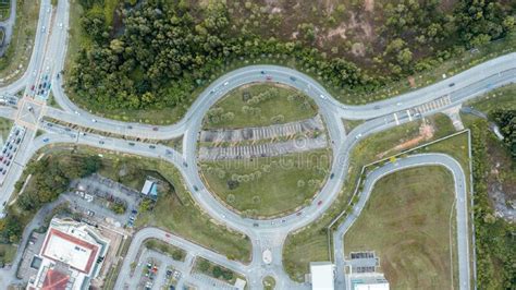 Top Down Aerial View Of A Traffic Roundabout On A Main Road In An Urban