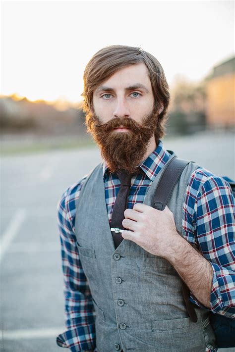 Portrait Of A Hip And Trendy Bearded Man In A Parking Lot By Stocksy Contributor Jakob