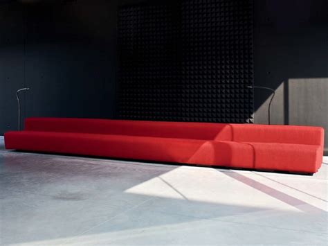 a red couch sitting on top of a cement floor
