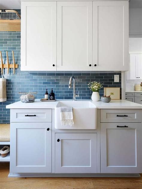 White shaker kitchen cabinets are still the top requested color in kitchen cabinetry. Gray shaker laundry room cabinets are accented with matte ...