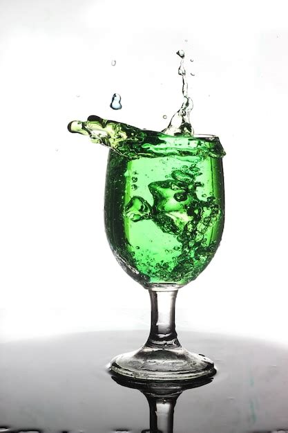 Premium Photo Green Water Splash In Wine Glass