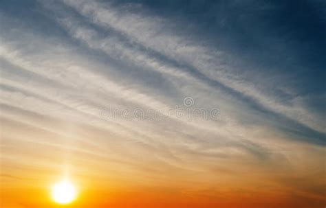 Stunning Sunset With Orange And Blue Clouds In Dramatic Sky Stock Image