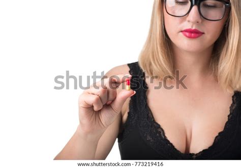 sexy woman with big boobs holding pill for potency isolated on white background