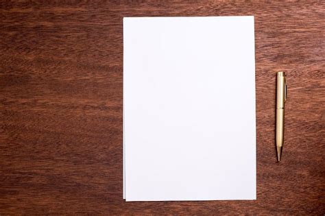 Free Image Of Blank Page Of Paper And Pen On A Wooden Table