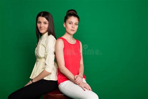 Two Brunette Girlfriends Posing On Green Background Stock Image Image