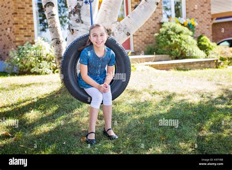 Portrait Of Girl On Tire Swing Stock Photo Alamy