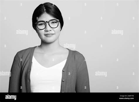 Studio Shot Of Young Asian Nerd Woman Wearing Eyeglasses Stock Photo