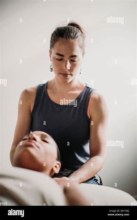 African American Woman Receives Massage Treatment From Her Therapist