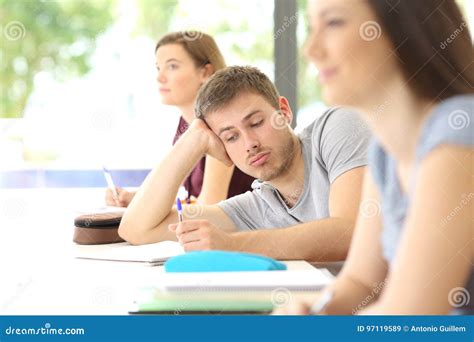 Bored Student Distracted During A Class At Classroom Stock Image