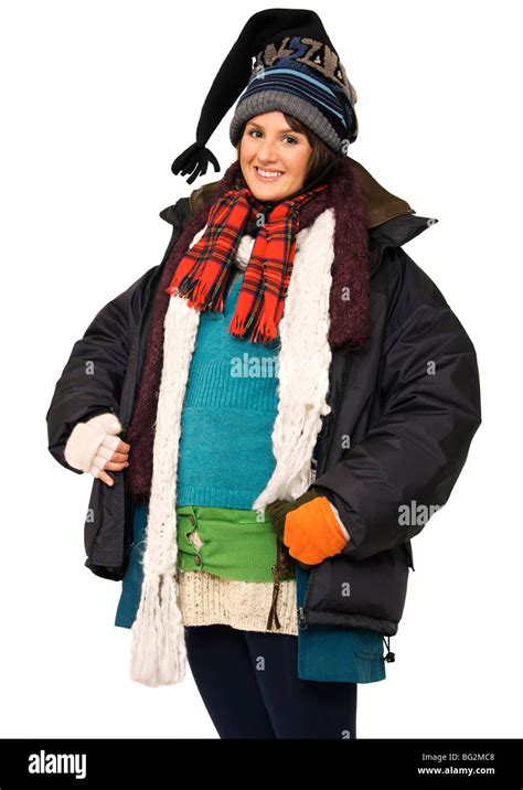 Happy Young Woman Wearing Multi Layers Of Clothing To Keep Warm Stock