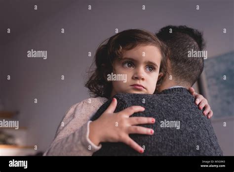 Father Embracing His Daughter In Living Room Stock Photo Alamy