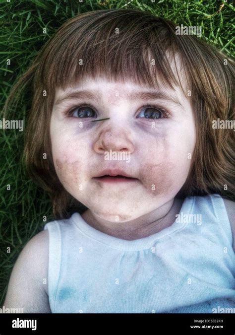 Toddler Caucasian Girl Laying In Grass Stock Photo Alamy