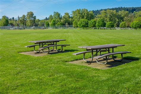 Picnic Tables In Public Park Featuring Park Grass And Lawn High