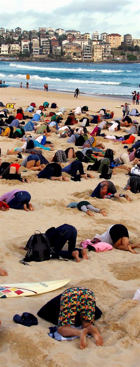 Australians Bury Heads In Sand To Mock Government Climate