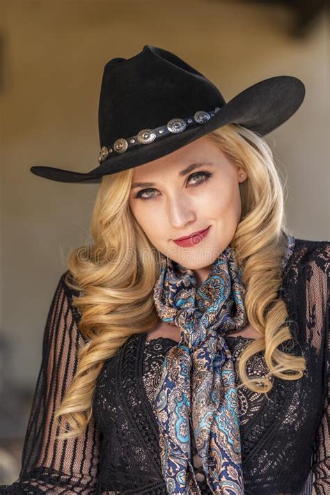 A Lovely Blonde Model Dressed As A Cowgirl Enjoys The American West