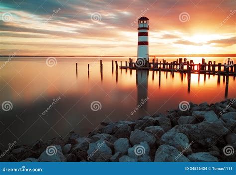 Sunset Sky And A Lighthouse Silhouette Stock Photo
