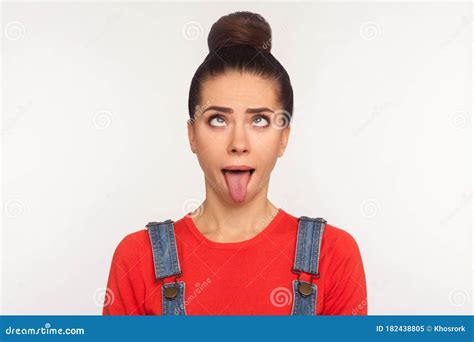 Closeup Of Amusing Funny Girl With Hair Bun Looking Up With Eyes