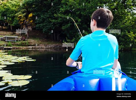 Little Boy Fishing In The Canoe On Lake Monate Stock Photo Alamy