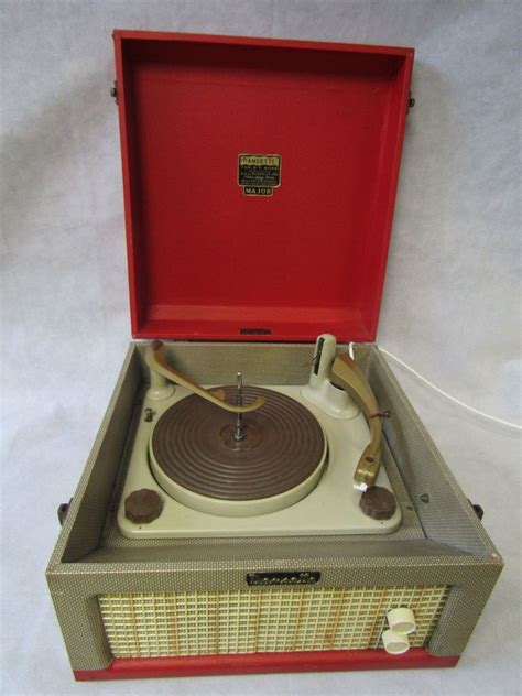 It features a surface for your record player, storage for your record collection, and a display for the record you are currently playing. Vintage 1960s Red Dansette Major Portable Record Player ...