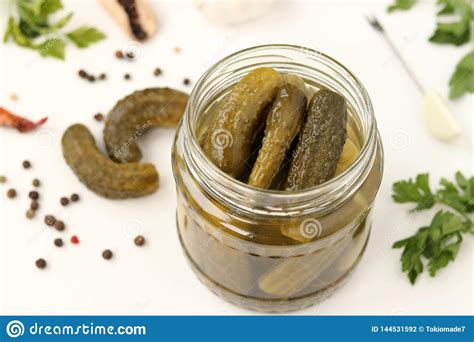 Pickled Gherkins In A Glass Jar On A White Background Top View Stock