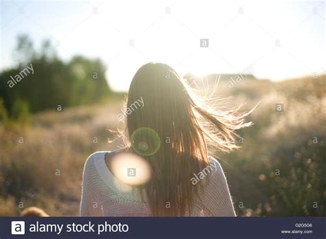 Teenage Girl With Wind Blowing Through Hair Rear View Stock Photo Alamy