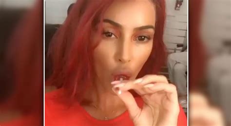 Kim Kardashian Debuts Red Hair Sucks Lollipop