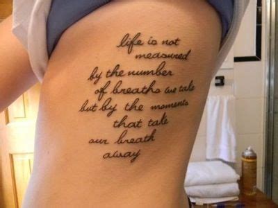 A Woman With A Tattoo On Her Back Saying Life Is Not Measured By The