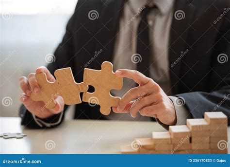 Closeup View Of Businessman Matching Two Puzzle Pieces Together Stock