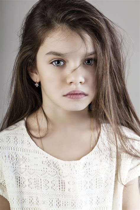 Portrait Of A Charming Little Girl Looking At Camera Stock Photo