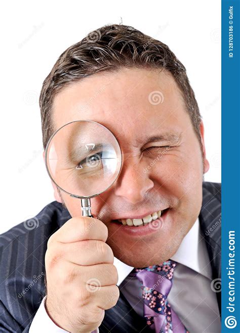 Businessman In A Suit Looking Through A Magnifying Glass