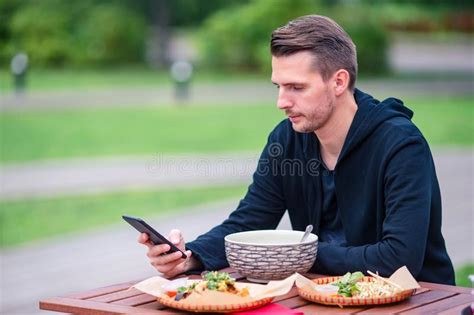 Young Man Eating Take Away Noodles On The Street Stock Photo Image Of