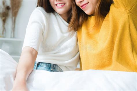 Beautiful Young Asian Women Lgbt Lesbian Couple Sitting On Bed Hugging And Smiling Together In