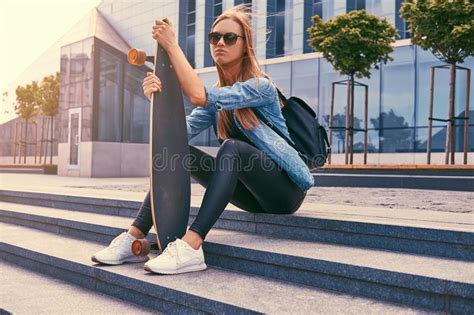 Young Hipster Blonde Girl In Casual Clothes And Sunglasses Sitting On