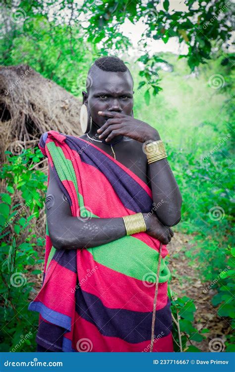 Portrait Of Pregnant African Woman In Bright Clothes In The Local Mursi Tribe Village Editorial