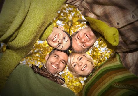 Group Of Happy Friends With Heads Together Stock Photo Image Of Green
