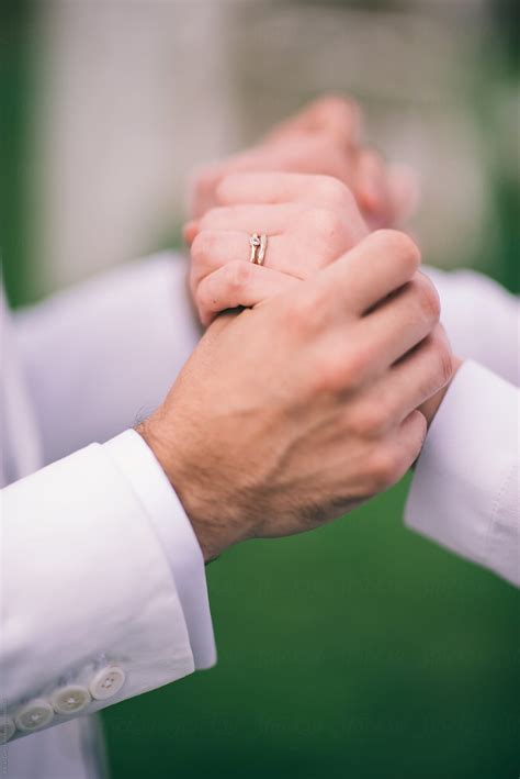 Bride And Groom Holding Hands Showing Their Wedding Rings Del Colaborador De Stocksy Adrian