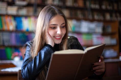 Beautiful Teenager Schoolgirl Sitting In The Library And Reading A Book Stock Image Image Of