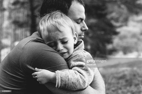 Father Hugging His Crying Son Stock Photo Getty Images