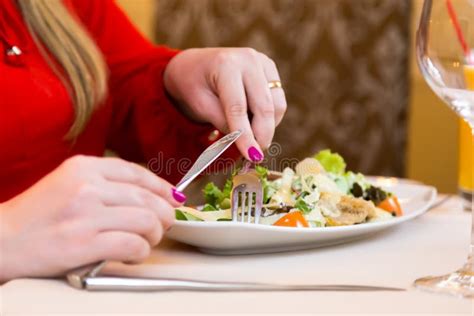 Woman Eating Salad With Salmon And Green Natural Foods And Healthy