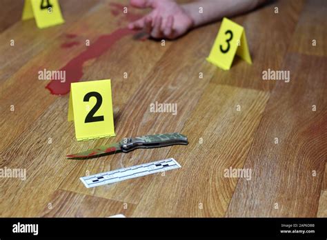 Crime Scene Investigation Bloody Knife And Victims Hand With Yellow