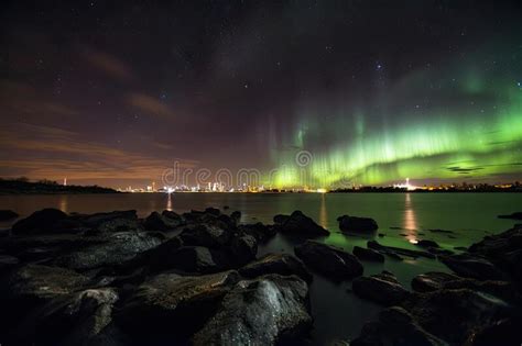 Nighttime Scene Of Aurora Borealis And Australis With City Lights In