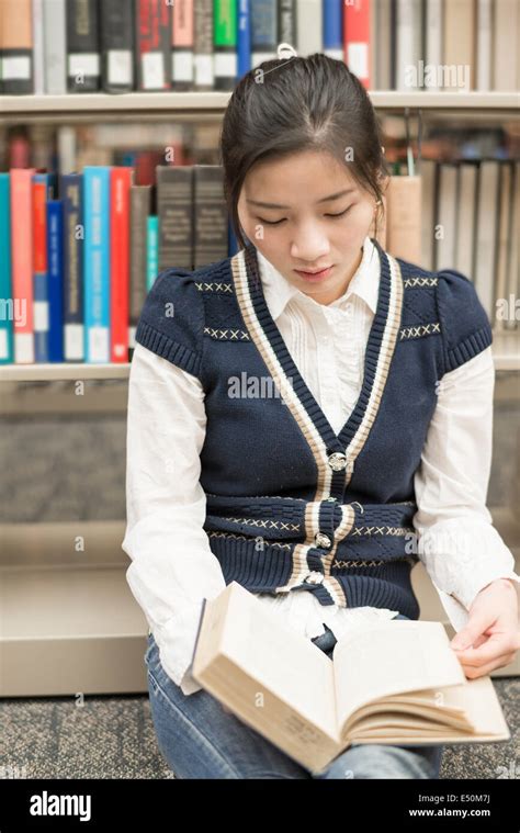 Girl Sitting On The Floor Reading Book Stock Photo Alamy