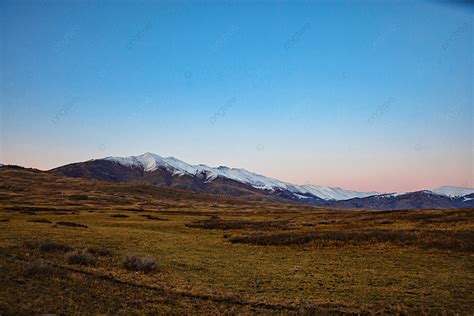 Snow Mountain And Grassland Background Snow Mountain Mountain